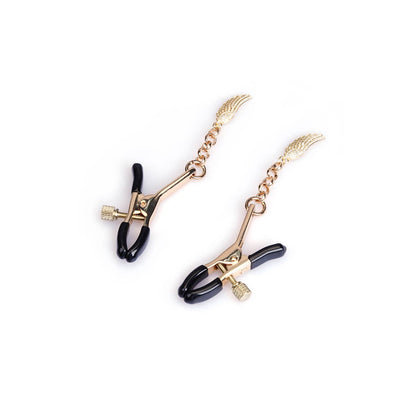 Close-up of polished zinc alloy nipple clamps with rubber tips and angel wing design – gold finish
