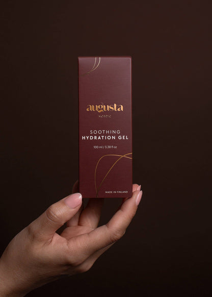 Hand holding a maroon box of Augusta Soothing Hydration Gel for sensitive skin