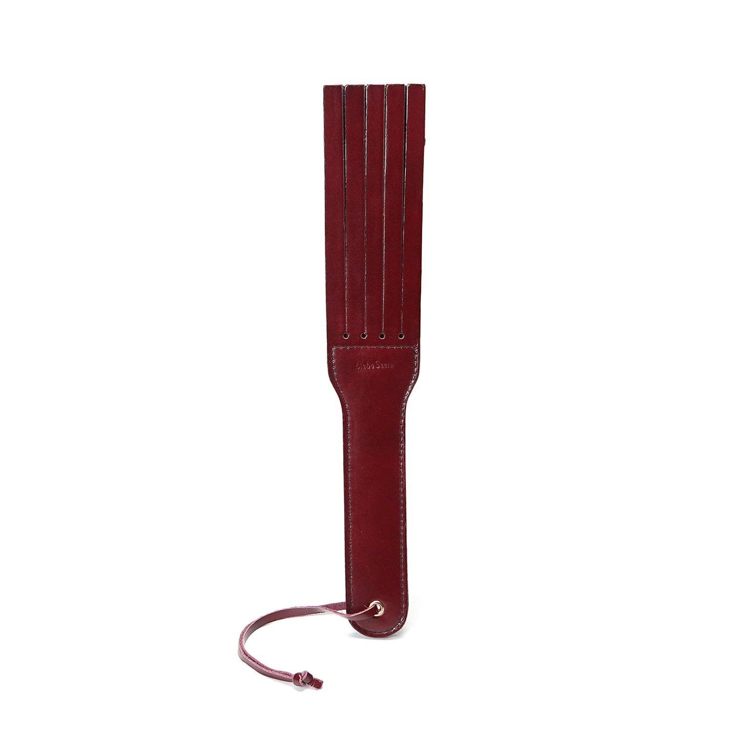 wine red leather split tawse paddle flat lay